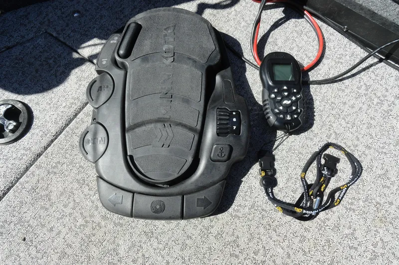 Slide: The Image of Foot pedal and remote control on a 2022 Tracker Targa V-19 Combo boat. - 19