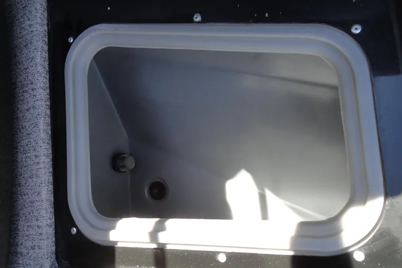 Slide: The Image of 2022 Tracker Targa V-19 Combo boat storage compartment, empty and open. - 21