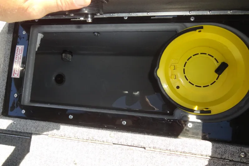 Slide: The Image of 2022 Tracker Targa V-19 Combo livewell with yellow bait bucket and water. - 25