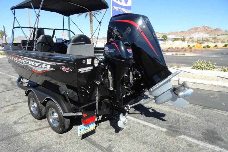 Slide: The Image of 2022 Tracker Targa V-19 Combo boat with dual outboard motors on a trailer. - 29