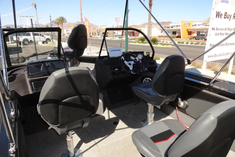 Slide: The Image of 2022 Tracker Targa V-19 Combo boat interior with seating and steering console. - 6