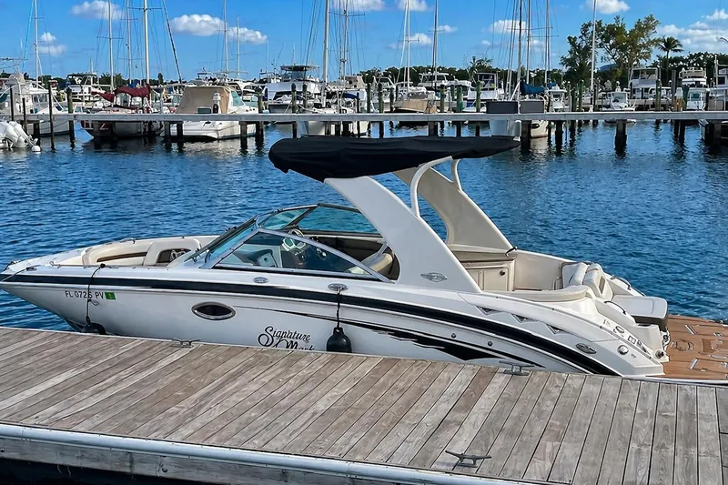 The Image of 2015 Chaparral 264 Sunesta boat docked at marina with clear blue sky. - 0