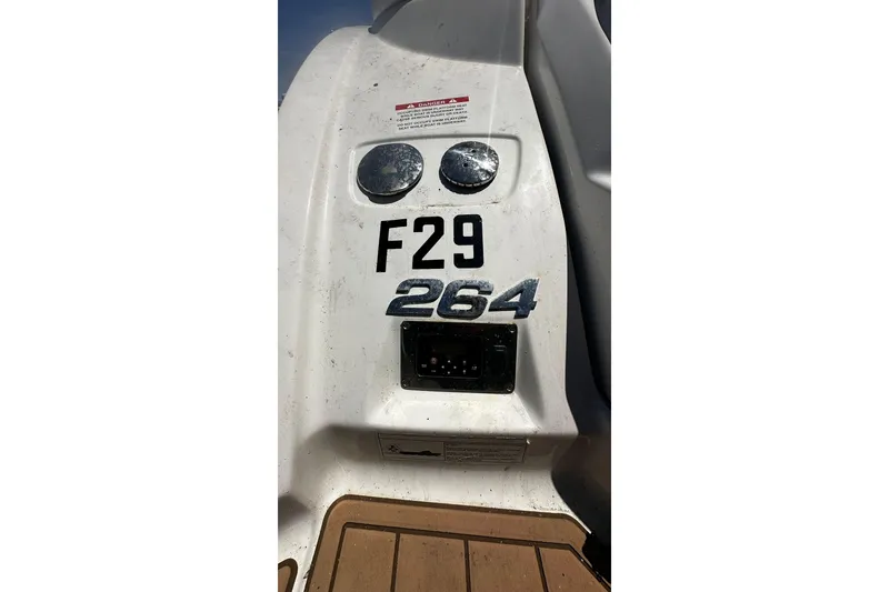 Slide: The Image of 2015 Chaparral 264 Sunesta boat stern with model number and gauges. - 11