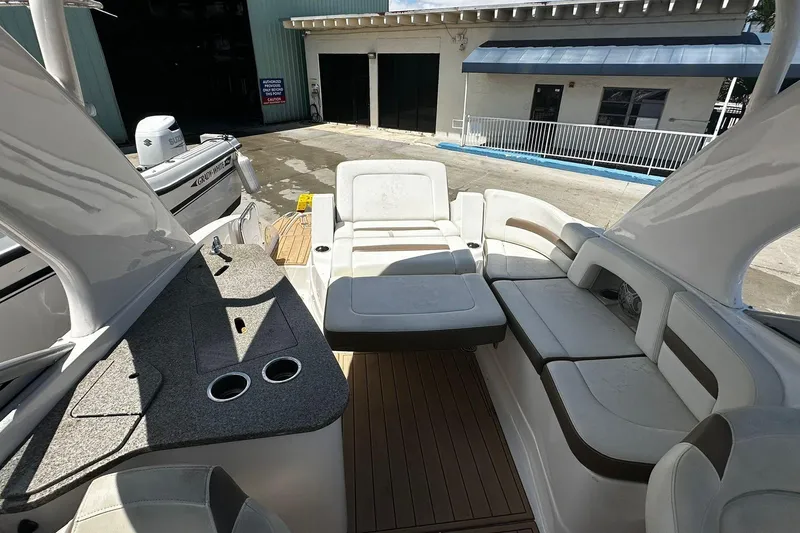Slide: The Image of 2015 Chaparral 264 Sunesta boat interior with spacious seating and sleek design. - 12