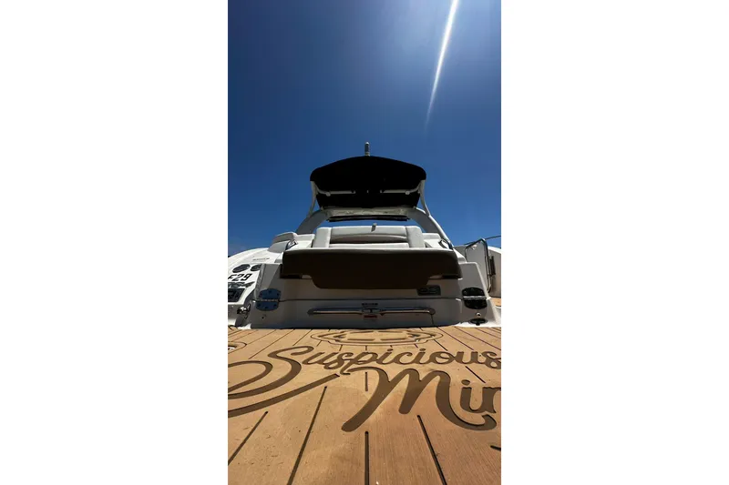 Slide: The Image of 2015 Chaparral 264 Sunesta boat under clear blue sky, viewed from the rear deck. - 17