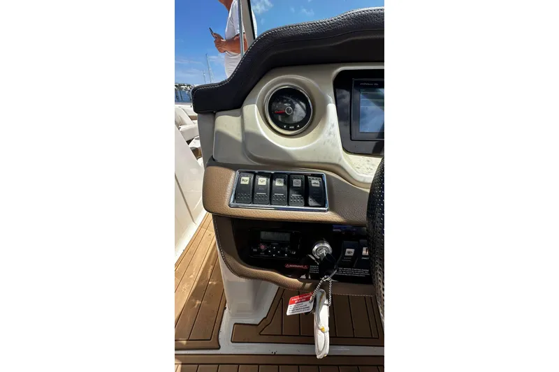 Slide: The Image of Dashboard of a 2015 Chaparral 264 Sunesta boat with controls and gauges. - 19