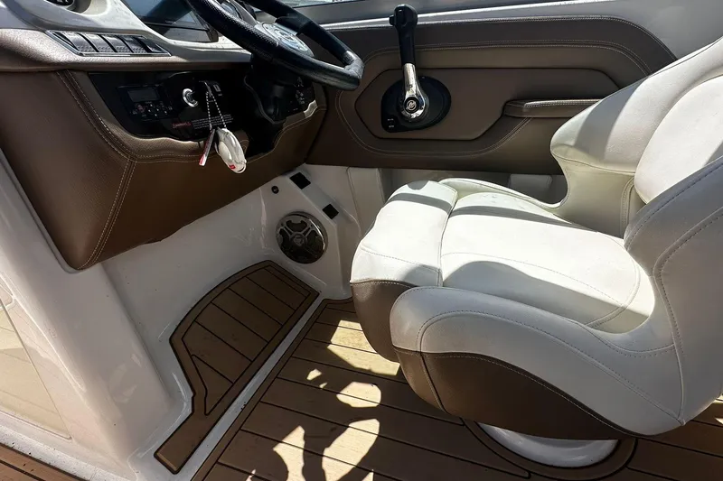 Slide: The Image of 2015 Chaparral 264 Sunesta boat interior with steering wheel and captain's seat. - 22