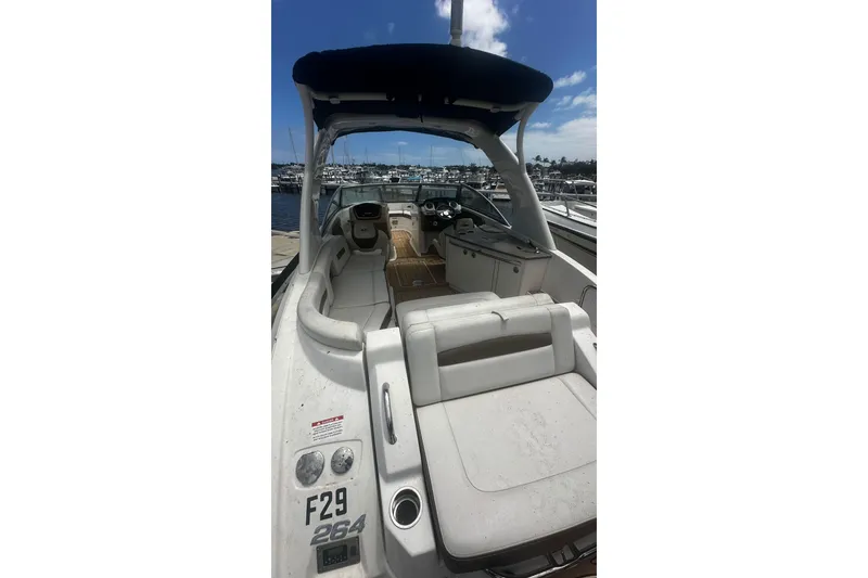 Slide: The Image of 2015 Chaparral 264 Sunesta boat interior with seating and dashboard, docked at marina. - 25