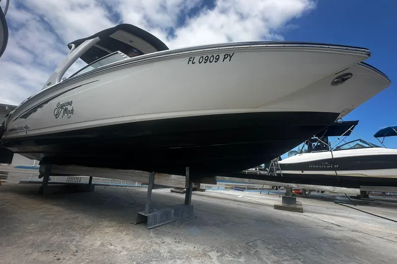 Slide: The Image of 2015 Chaparral 264 Sunesta boat on dry dock under a partly cloudy sky. - 5