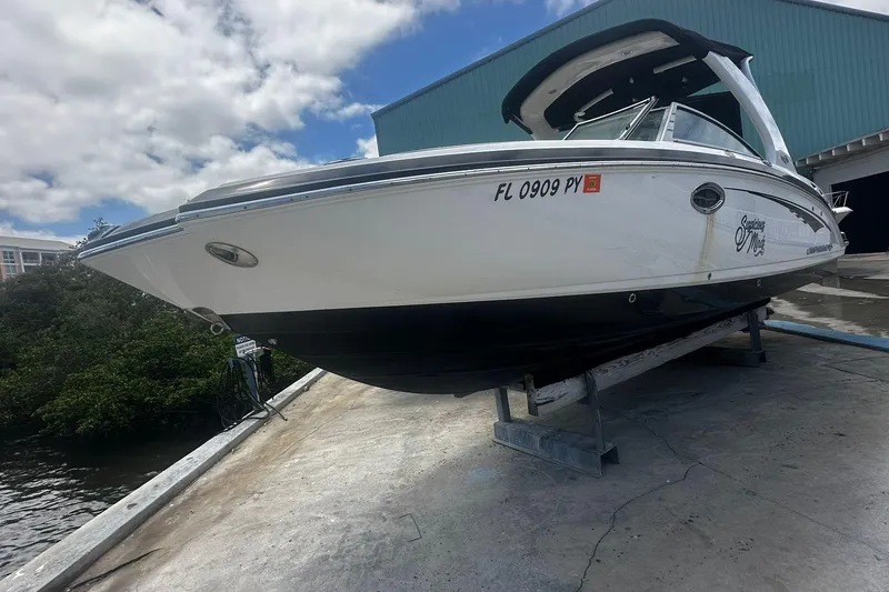 Slide: The Image of 2015 Chaparral 264 Sunesta boat on dry dock under a partly cloudy sky. - 6