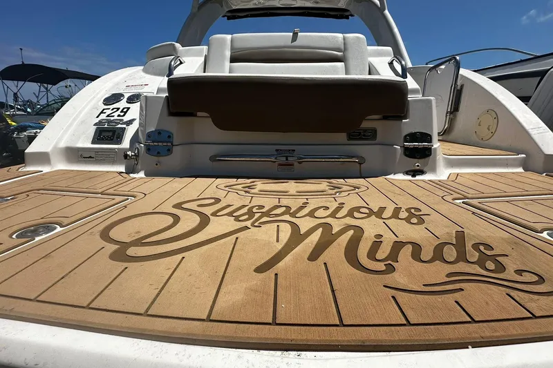 Slide: The Image of 2015 Chaparral 264 Sunesta boat with "Suspicious Minds" on deck, sunny day. - 8