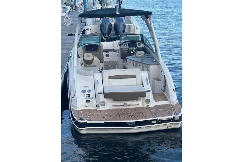Slide: The Image of 2015 Chaparral 264 Sunesta boat docked, featuring spacious seating and dual engines. - 9