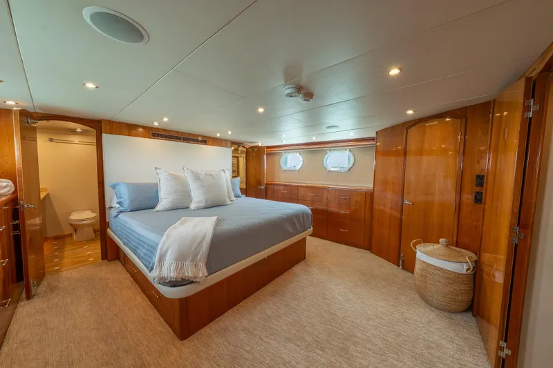 Slide: The Image of Luxurious bedroom interior of 2004 Hatteras 75 Sport Deck Motor Yacht with elegant wood finishes. - 12