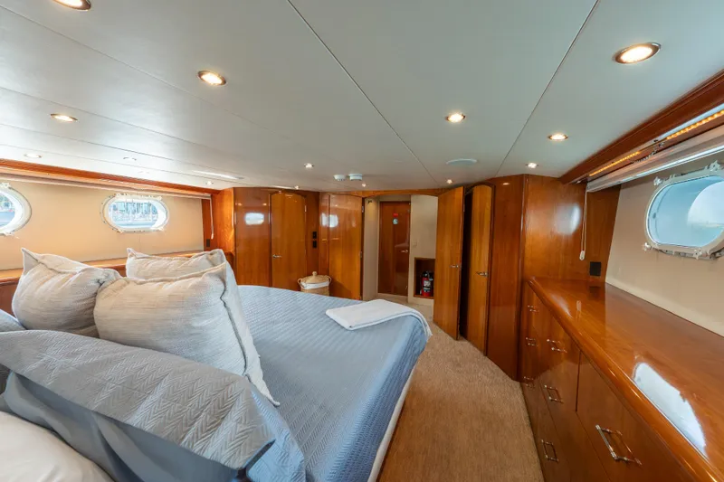 Slide: The Image of Luxurious bedroom interior of 2004 Hatteras 75 Sport Deck Motor Yacht with wood finishes. - 13