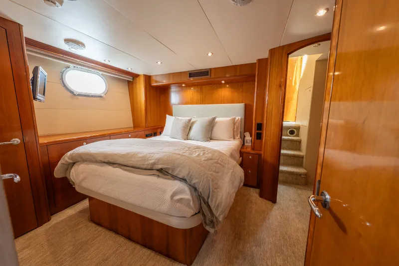 Slide: The Image of Luxurious bedroom interior of 2004 Hatteras 75 Sport Deck Motor Yacht with wood paneling. - 18