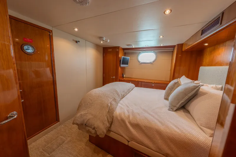Slide: The Image of Luxurious bedroom interior of 2004 Hatteras 75 Sport Deck Motor Yacht with cozy bedding. - 19
