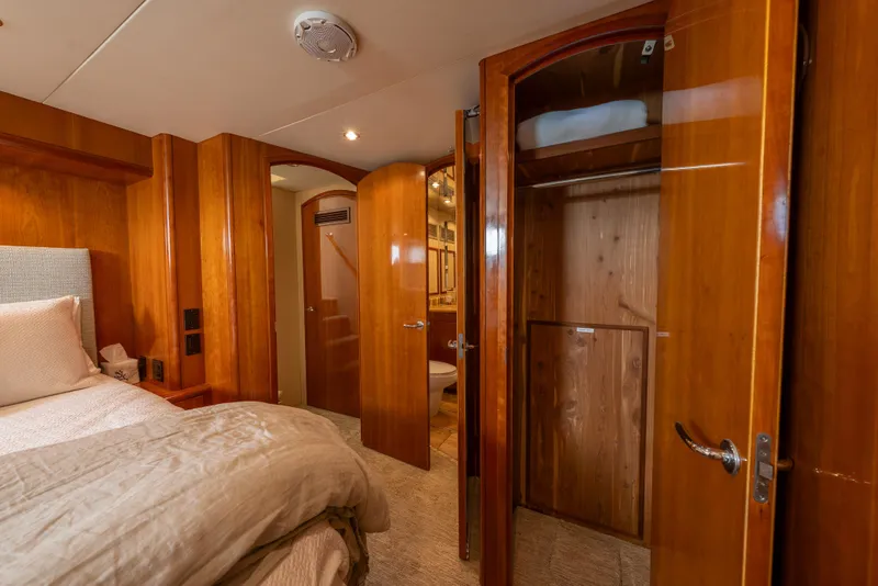Slide: The Image of Luxurious 2004 Hatteras 75 Sport Deck Motor Yacht bedroom with wooden interior and cozy bedding. - 20
