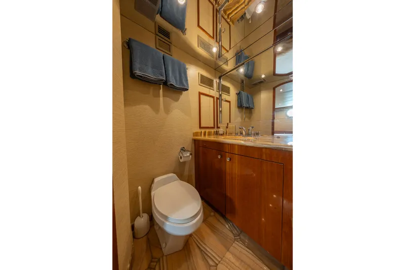 Slide: The Image of Luxurious bathroom in 2004 Hatteras 75 Sport Deck Motor Yacht with wooden cabinetry and modern fixtures. - 21