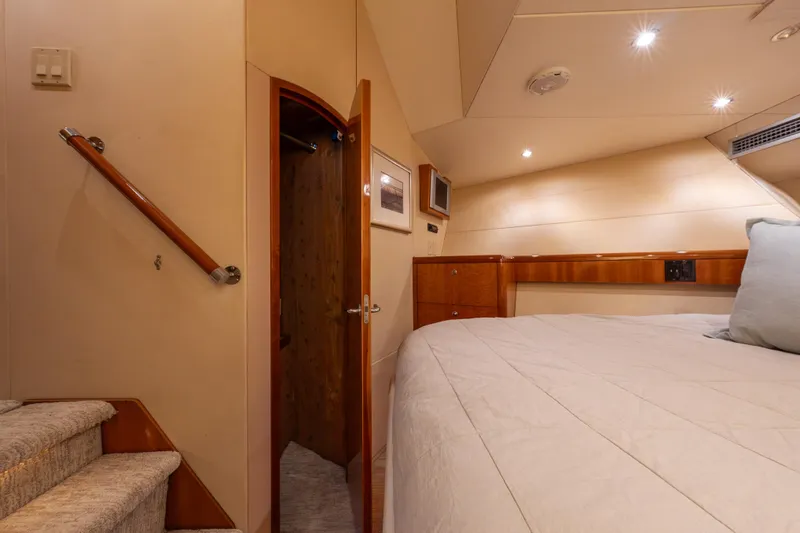 Slide: The Image of Luxurious bedroom interior of 2004 Hatteras 75 Sport Deck Motor Yacht with cozy bedding. - 24