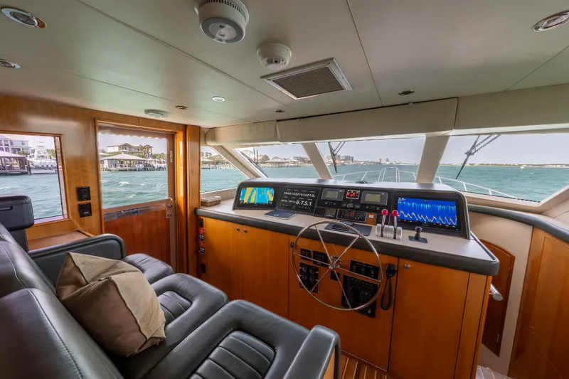 Slide: The Image of Interior helm of 2004 Hatteras 75 Sport Deck Motor Yacht with navigation equipment and leather seating. - 29
