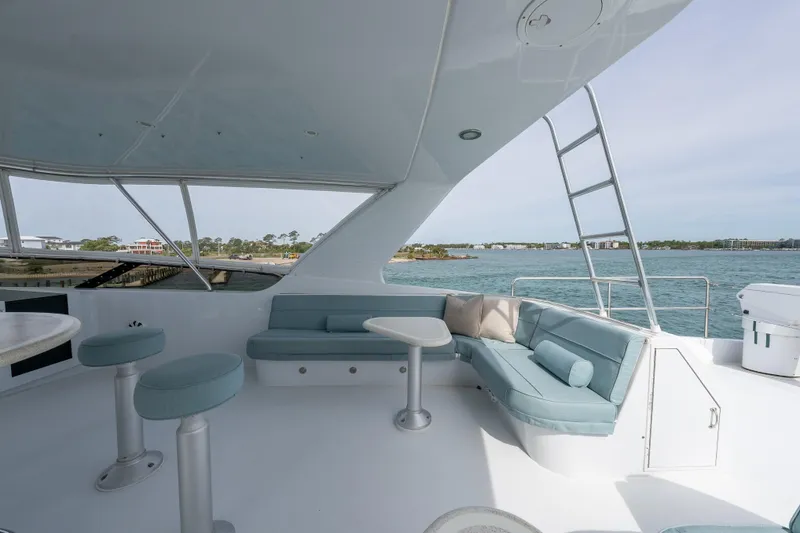 Slide: The Image of Luxurious 2004 Hatteras 75 Sport Deck Motor Yacht with elegant seating and ocean view. - 33
