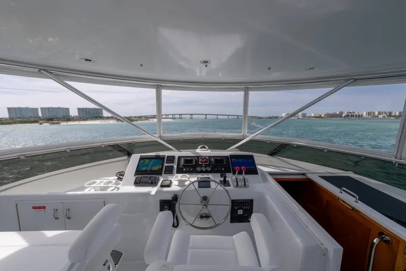 Slide: The Image of Helm of 2004 Hatteras 75 Sport Deck Motor Yacht with ocean view and modern controls. - 37