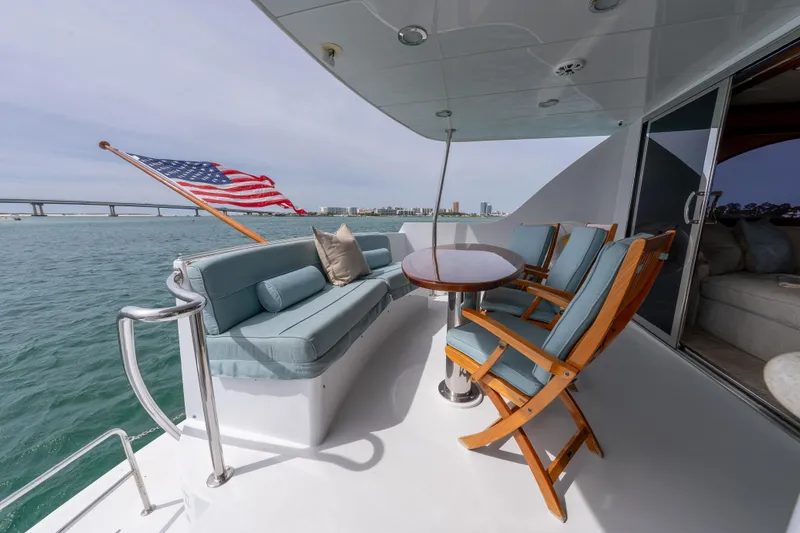 Slide: The Image of Luxurious 2004 Hatteras 75 Sport Deck Motor Yacht with elegant seating and ocean view. - 41