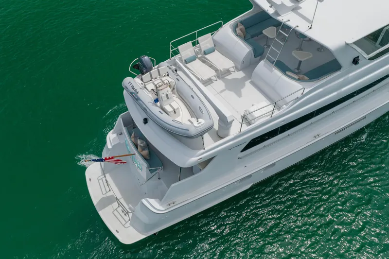Slide: The Image of Aerial view of 2004 Hatteras 75 Sport Deck Motor Yacht on turquoise water. - 49
