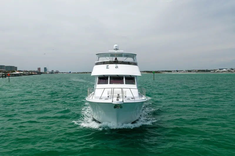 Slide: The Image of 2004 Hatteras 75 Sport Deck Motor Yacht cruising on open water. - 57