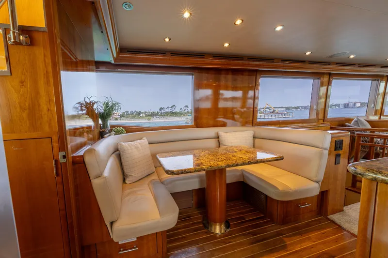 Slide: The Image of Luxurious dining area in 2004 Hatteras 75 Sport Deck Motor Yacht with scenic views. - 8