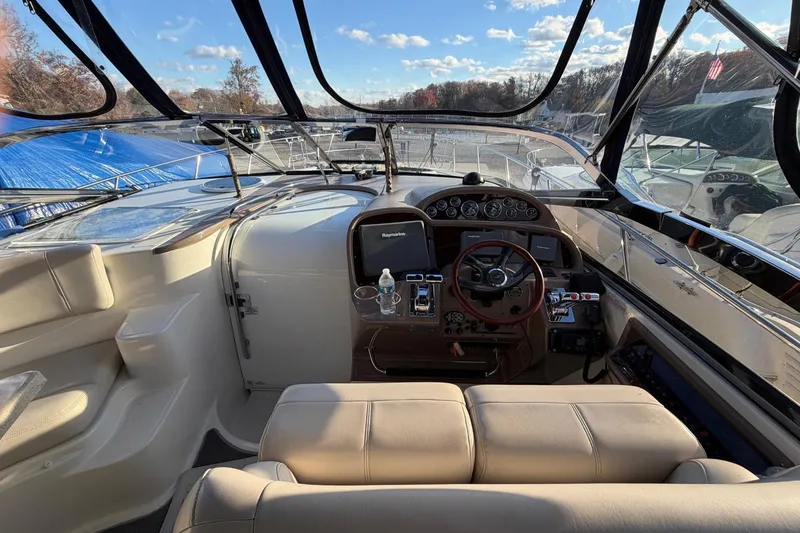 Slide: The Image of Interior view of 2002 Regal Commodore 3860 yacht cockpit with steering wheel and controls. - 11