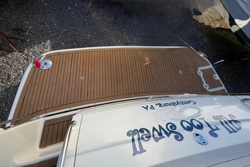 Slide: The Image of 2002 Regal Commodore 3860 boat with teak deck, docked on gravel. - 6