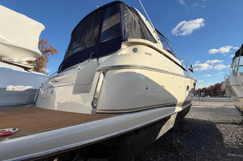 Slide: The Image of 2002 Regal Commodore 3860 yacht on dry dock under clear blue sky. - 5