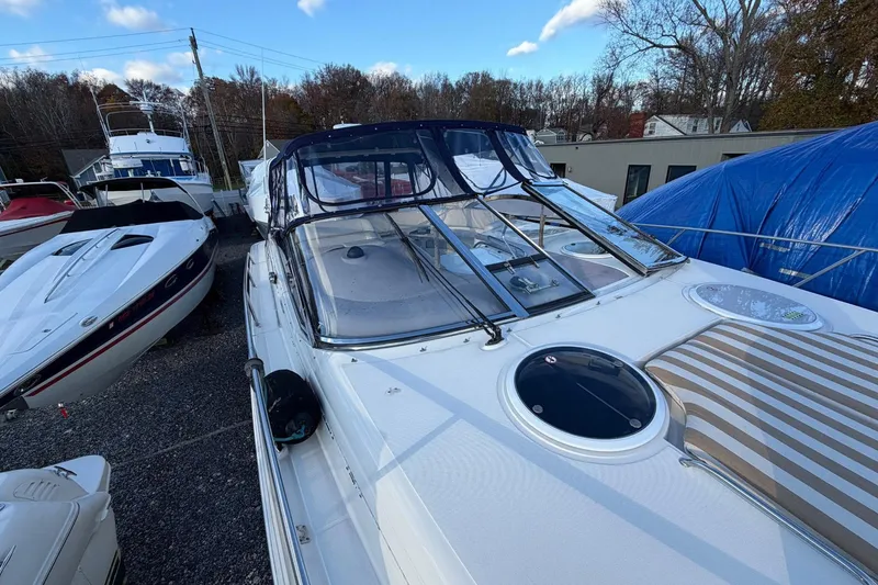 Slide: The Image of 2002 Regal Commodore 3860 yacht docked, showcasing sleek design and spacious deck. - 22