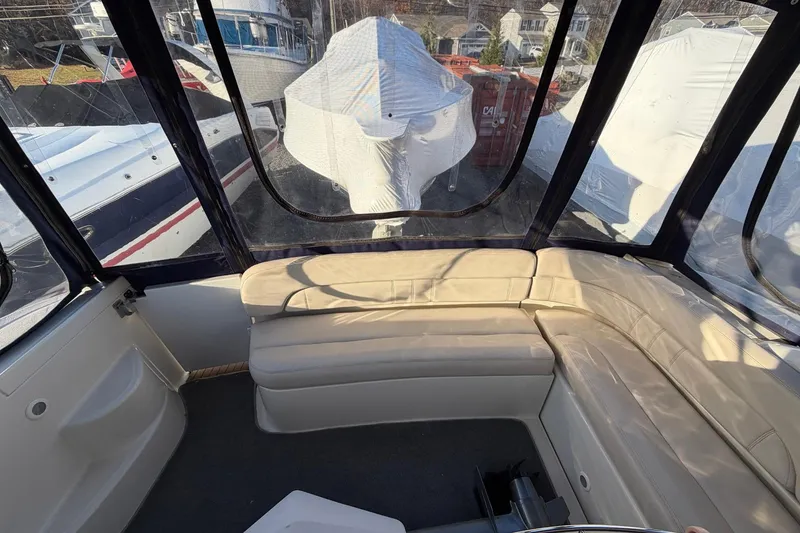 Slide: The Image of Interior of a 2002 Regal Commodore 3860 yacht with beige seating and clear windows. - 10