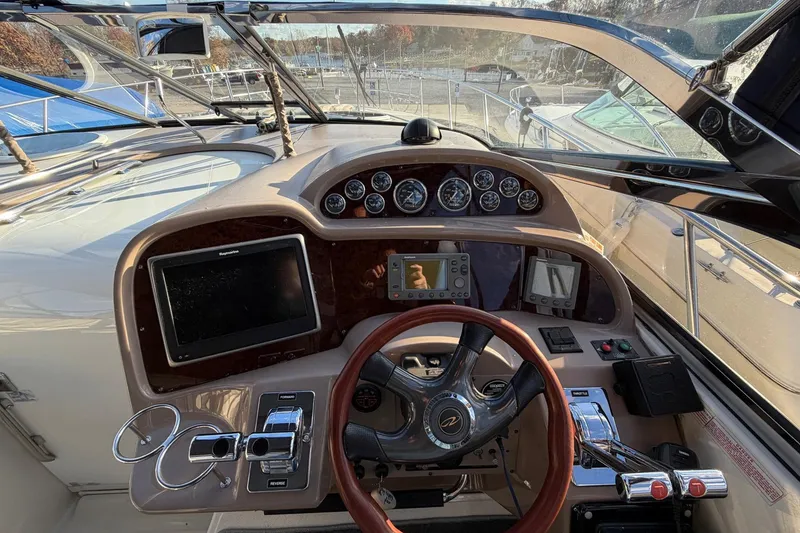 Slide: The Image of Cockpit of 2002 Regal Commodore 3860 yacht with steering wheel and navigation instruments. - 12