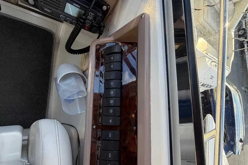 Slide: The Image of Control panel of a 2002 Regal Commodore 3860 boat with radio and switches. - 13