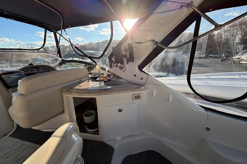 Slide: The Image of Interior of a 2002 Regal Commodore 3860 yacht with sunlit dashboard and seating area. - 9