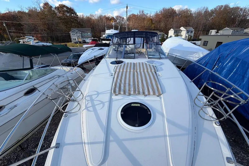 Slide: The Image of 2002 Regal Commodore 3860 yacht docked, surrounded by other boats, under a clear sky. - 20