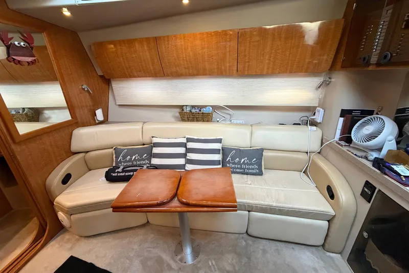 Slide: The Image of Interior of 2002 Regal Commodore 3860 yacht with beige seating and wooden accents. - 24