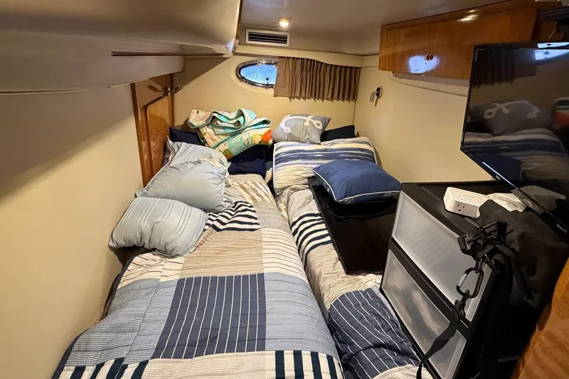 Slide: The Image of Cozy cabin interior of 2002 Regal Commodore 3860 with bed and TV. - 32