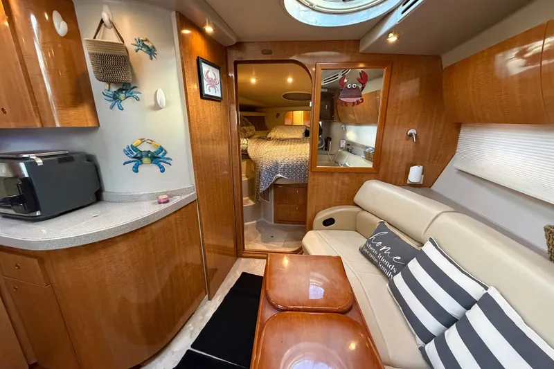 Slide: The Image of Interior of 2002 Regal Commodore 3860 yacht with cozy seating and nautical decor. - 26