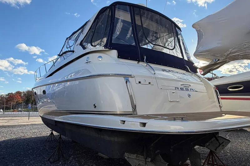 Slide: The Image of 2002 Regal Commodore 3860 yacht on display under a clear blue sky. - 3