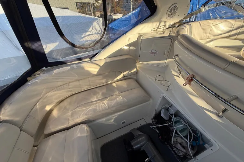 Slide: The Image of Interior of 2002 Regal Commodore 3860 yacht with white leather seating and storage area. - 8