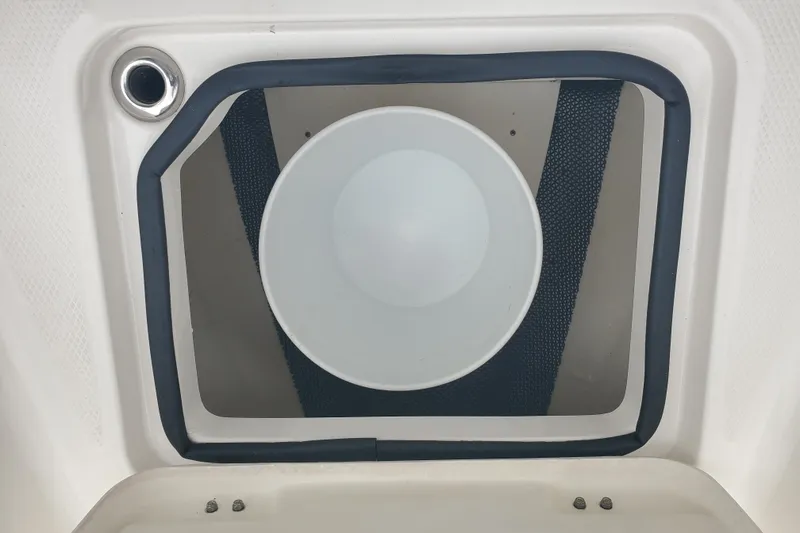 Slide: The Image of 2020 Robalo R222 Explorer boat hatch with circular light and black trim. - 20