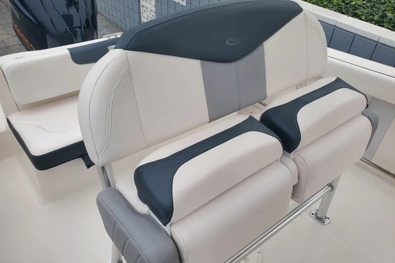 Slide: The Image of 2020 Robalo R222 Explorer boat seating with cushioned backrest and armrests. - 5