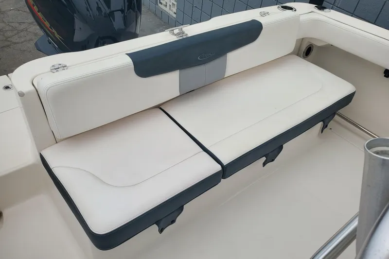 Slide: The Image of 2020 Robalo R222 Explorer boat seating with white and gray upholstery. - 7