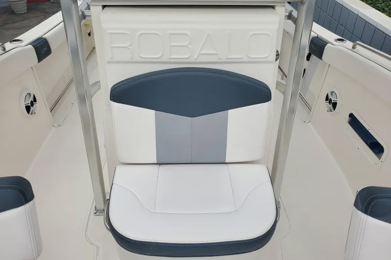 Slide: The Image of 2020 Robalo R222 Explorer boat interior with cushioned seating and branded backrest. - 9