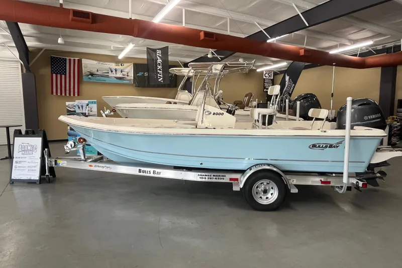 The Image of 2026 Bulls Bay 2000 boat displayed indoors on a trailer at a showroom. - 1