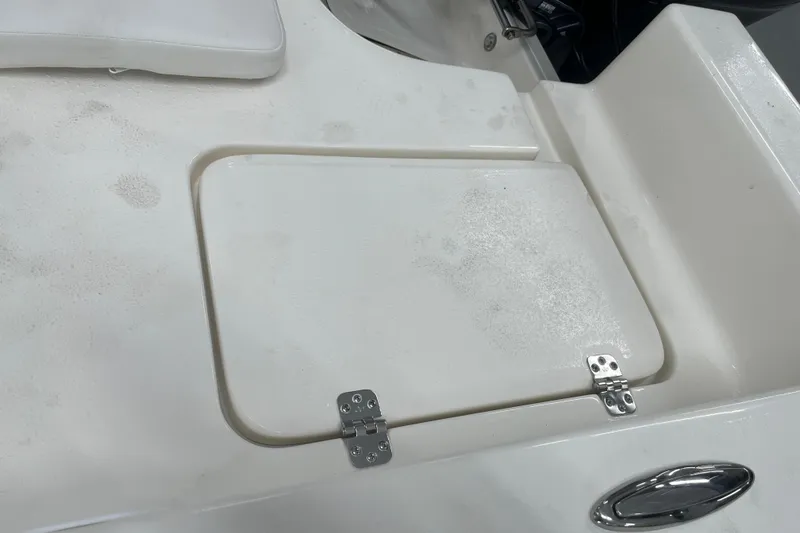 Slide: The Image of Hinged compartment on 2026 Bulls Bay 2000 boat deck, featuring sleek white finish. - 11